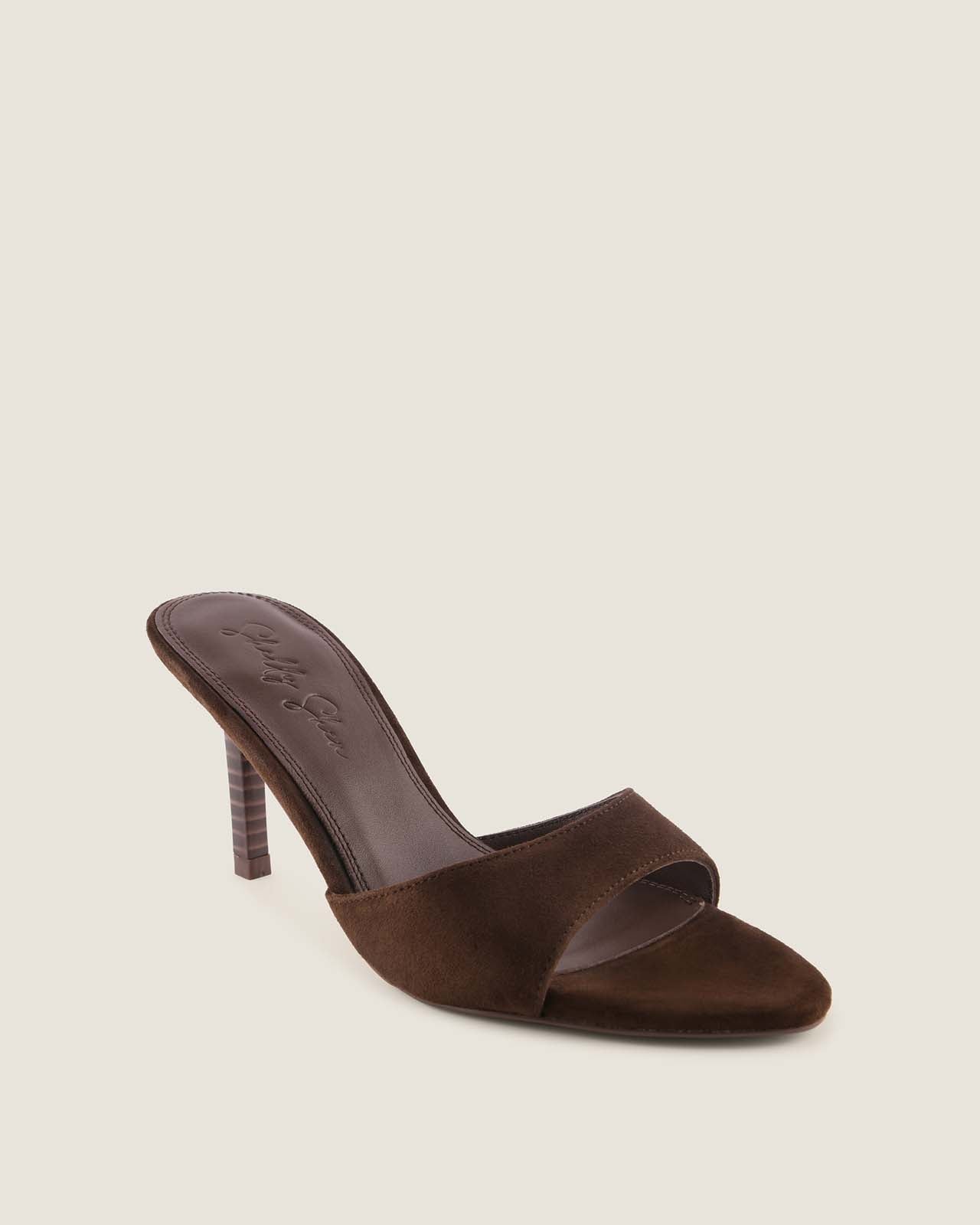 Brown high-heeled sandal on a beige background