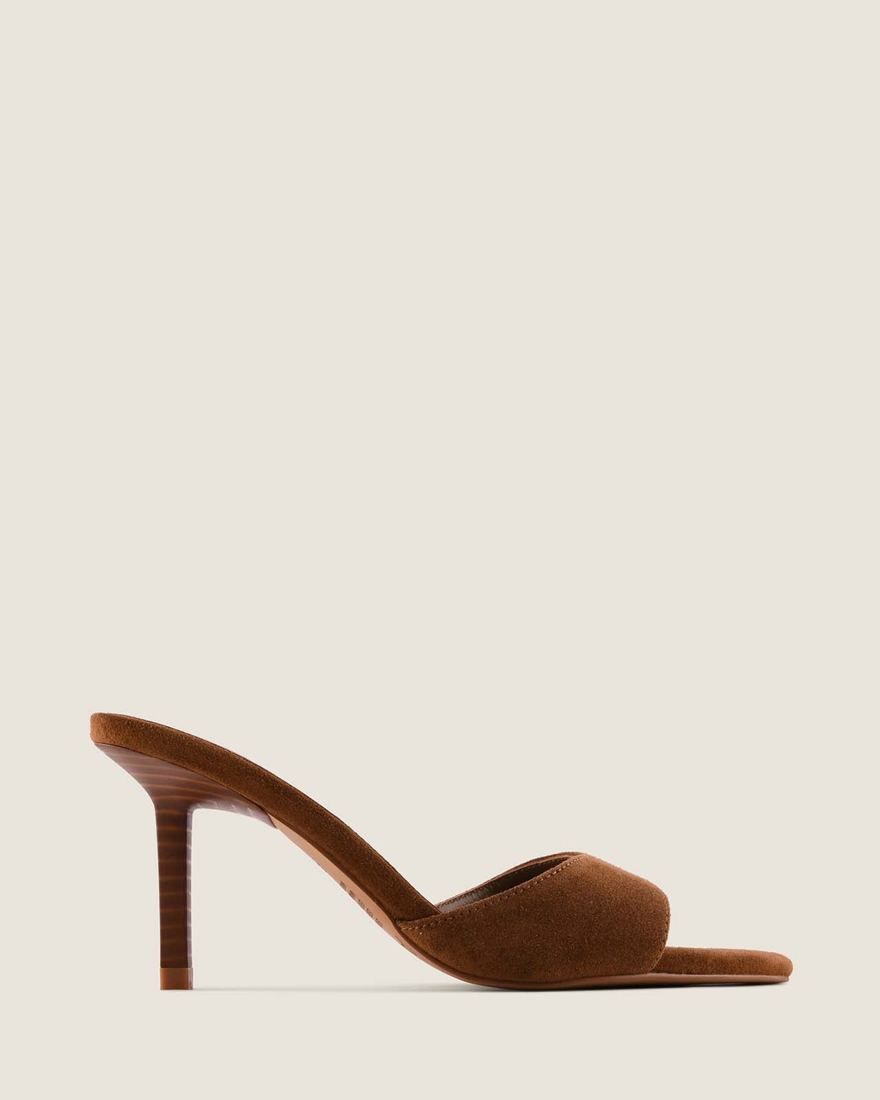 Brown suede high-heeled shoe on a light beige background