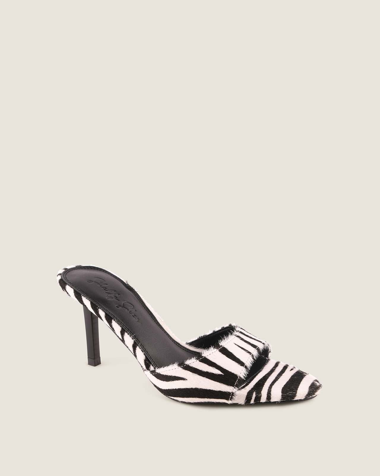 Zebra print high-heeled shoe on a beige background