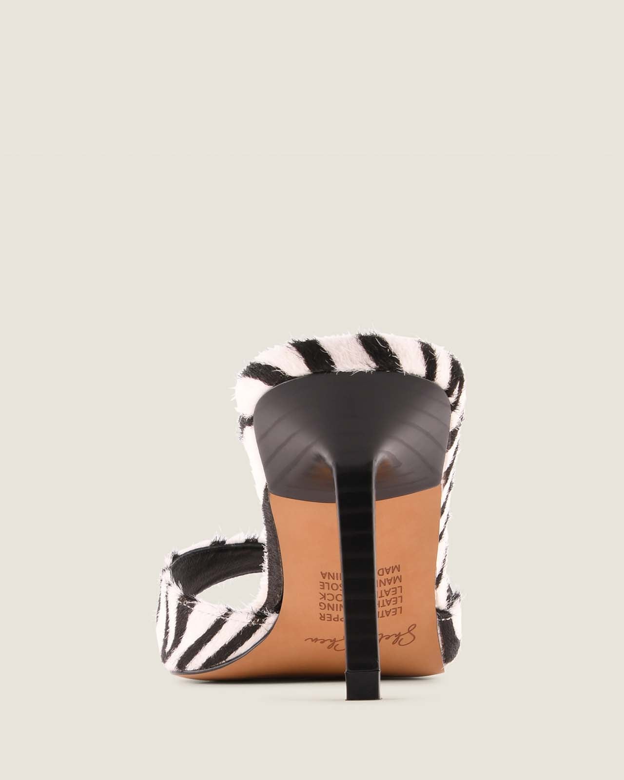 Back of high-heeled shoe with zebra pattern.