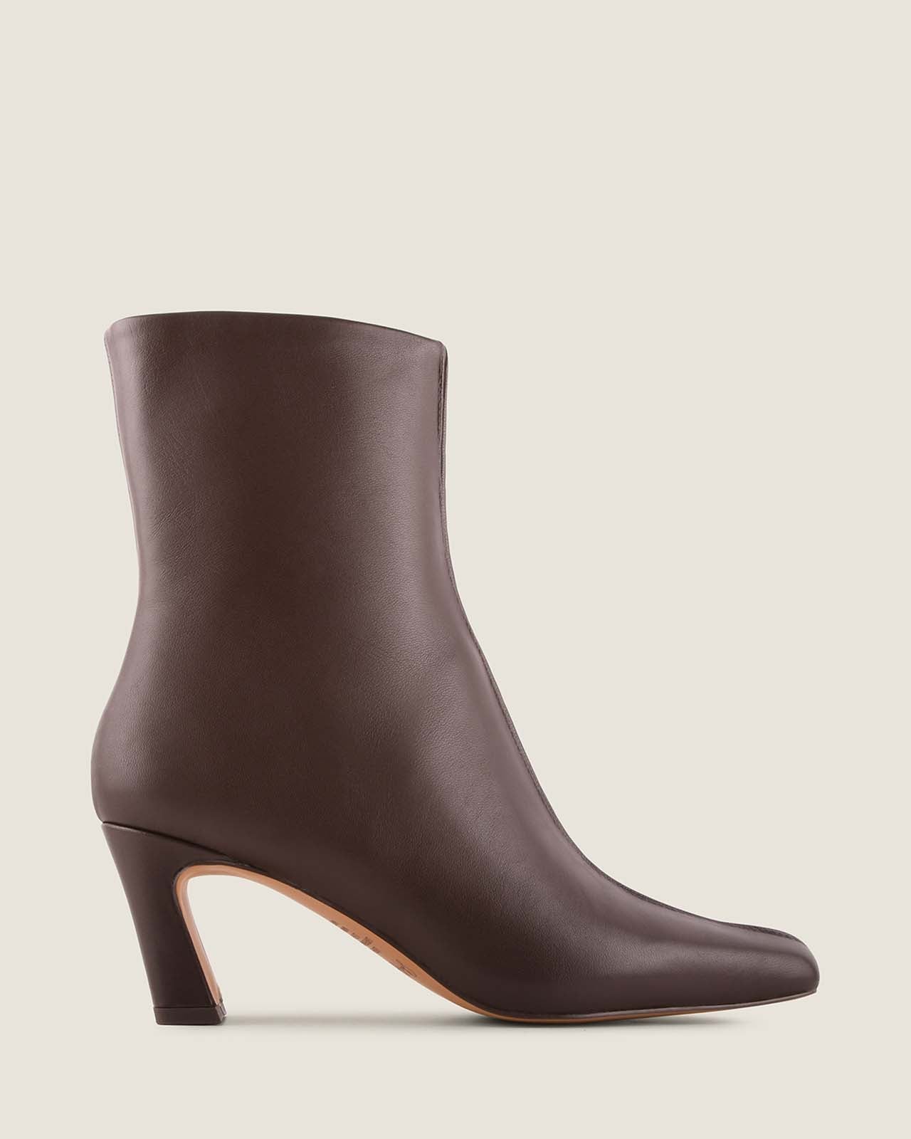 Brown ankle boot on a beige background