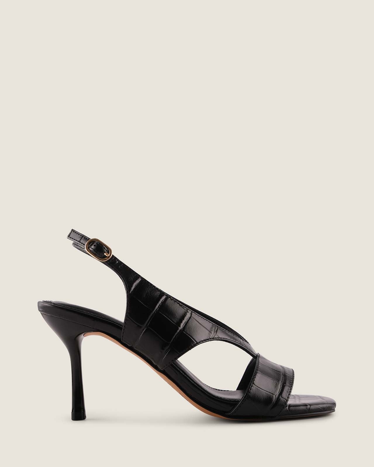 Black high-heeled sandal on a light gray background