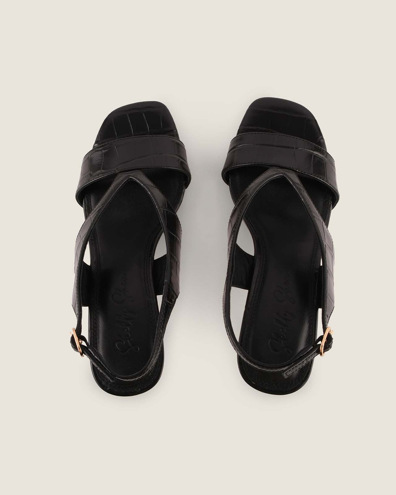 Pair of black sandals on a light gray background