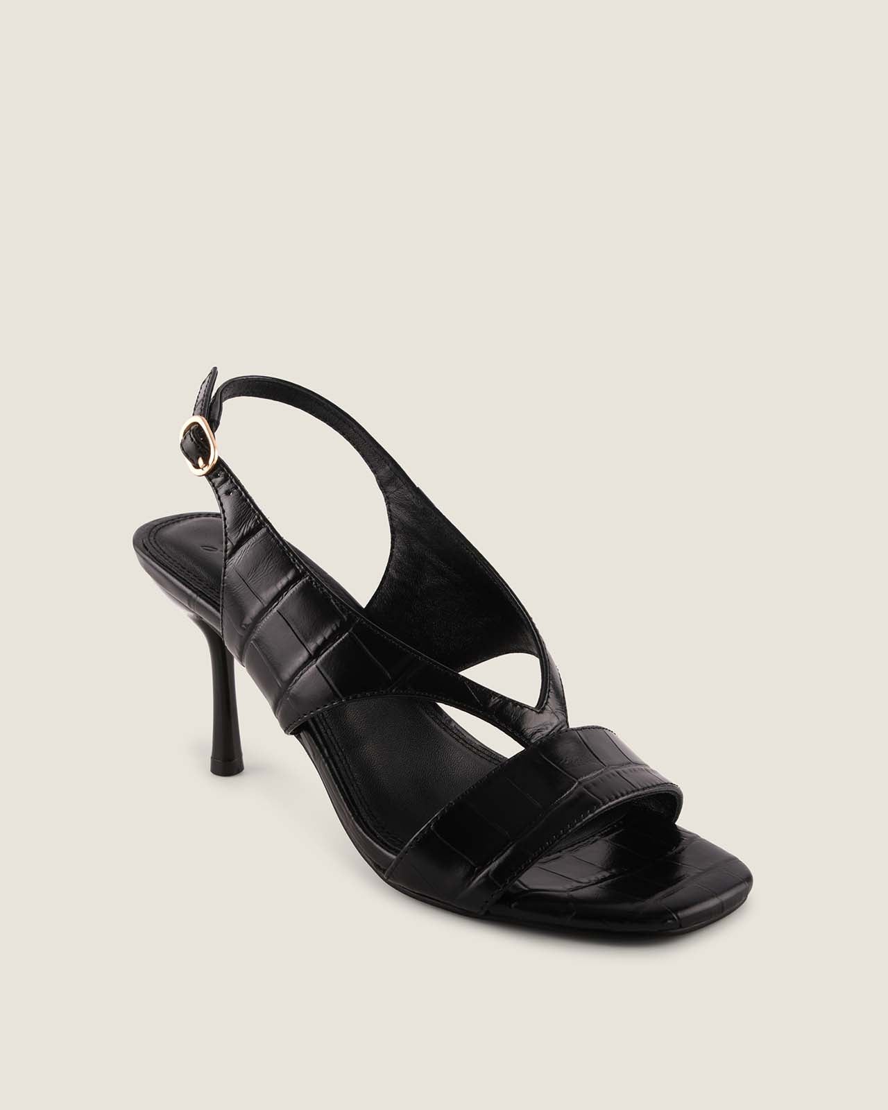 Black high-heeled sandal on a light gray background