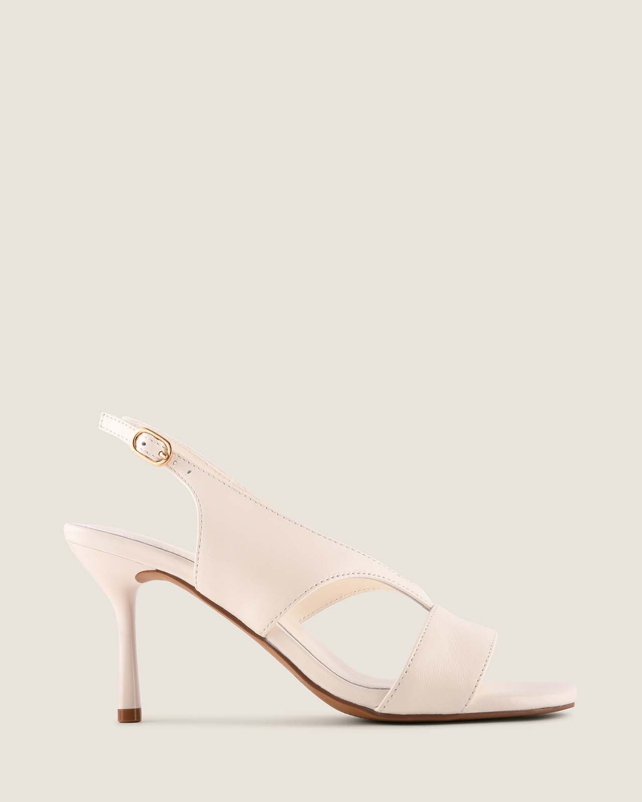 White high-heeled sandal on a light grey background