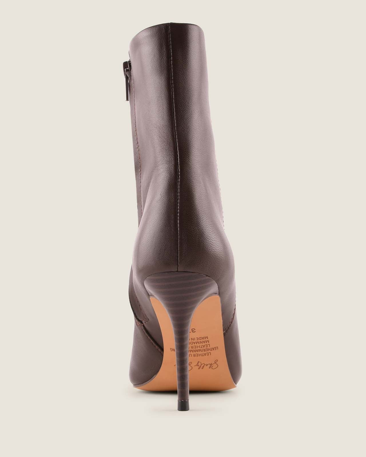 Brown leather ankle boot on a light gray background