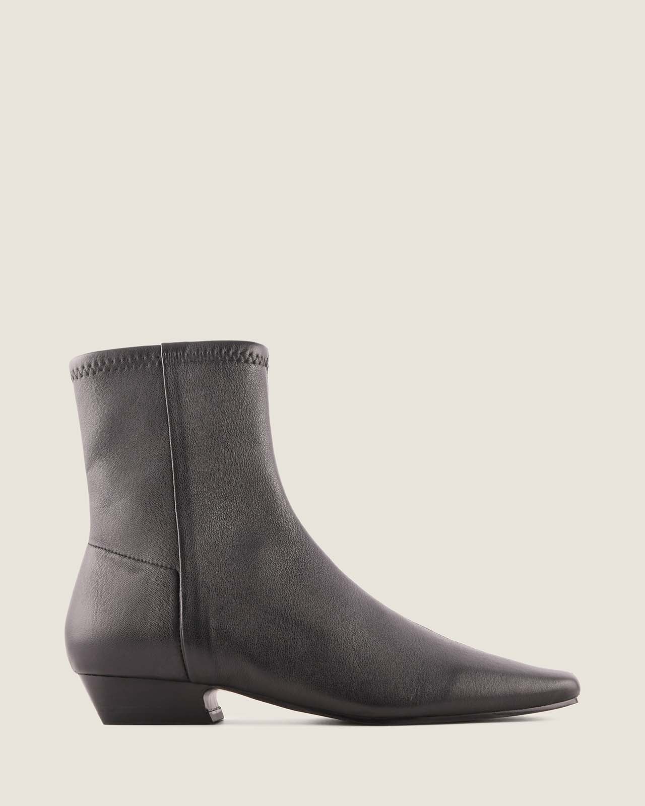 Black ankle boot on a light grey background