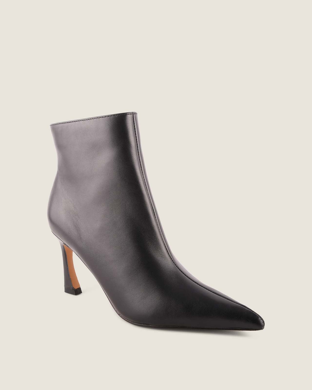Black ankle boot with a pointed toe on a light grey background