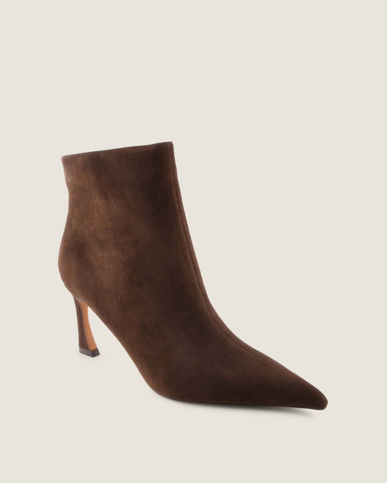 Brown suede ankle boot on a beige background