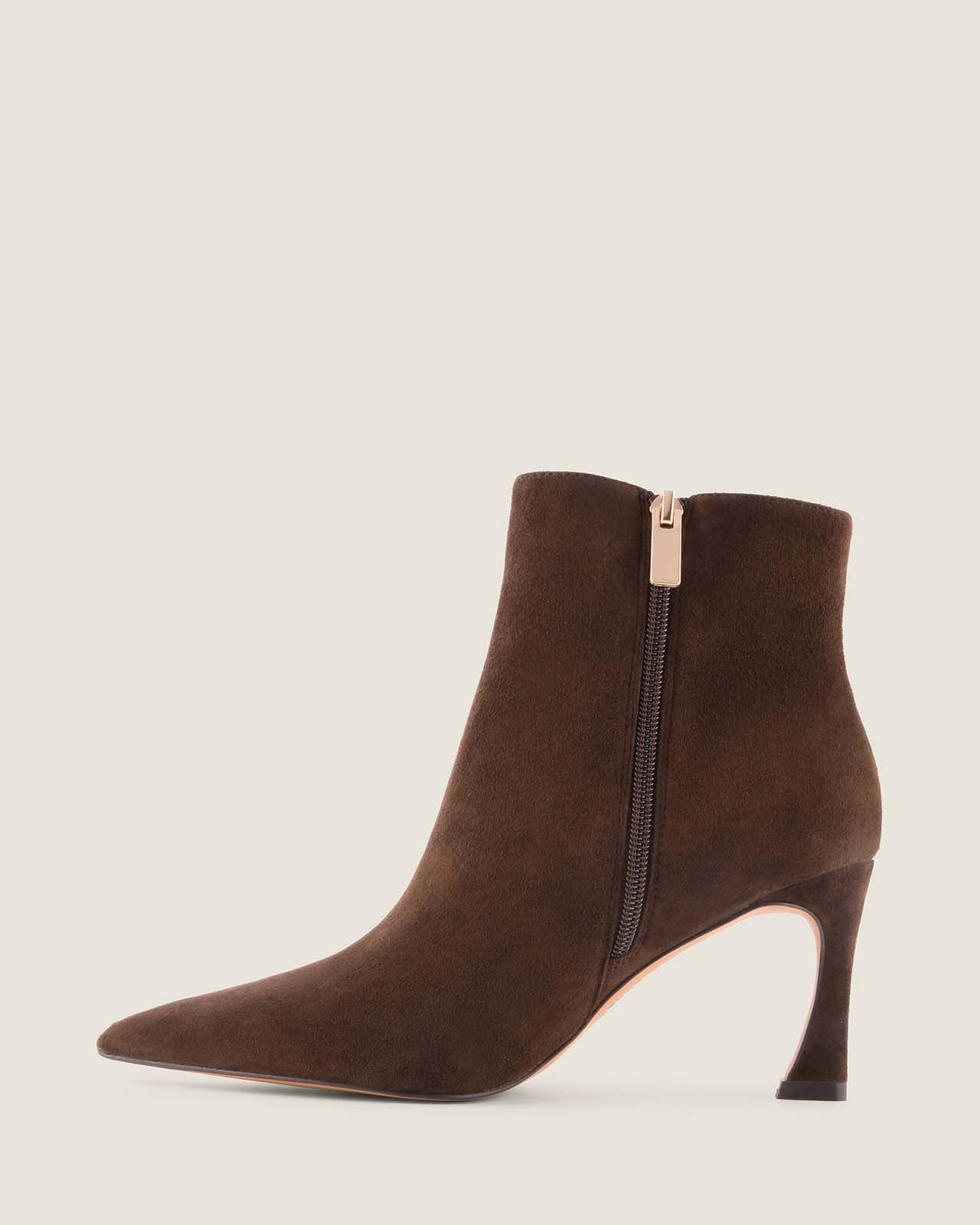 Brown suede ankle boot with a gold zipper on a light grey background