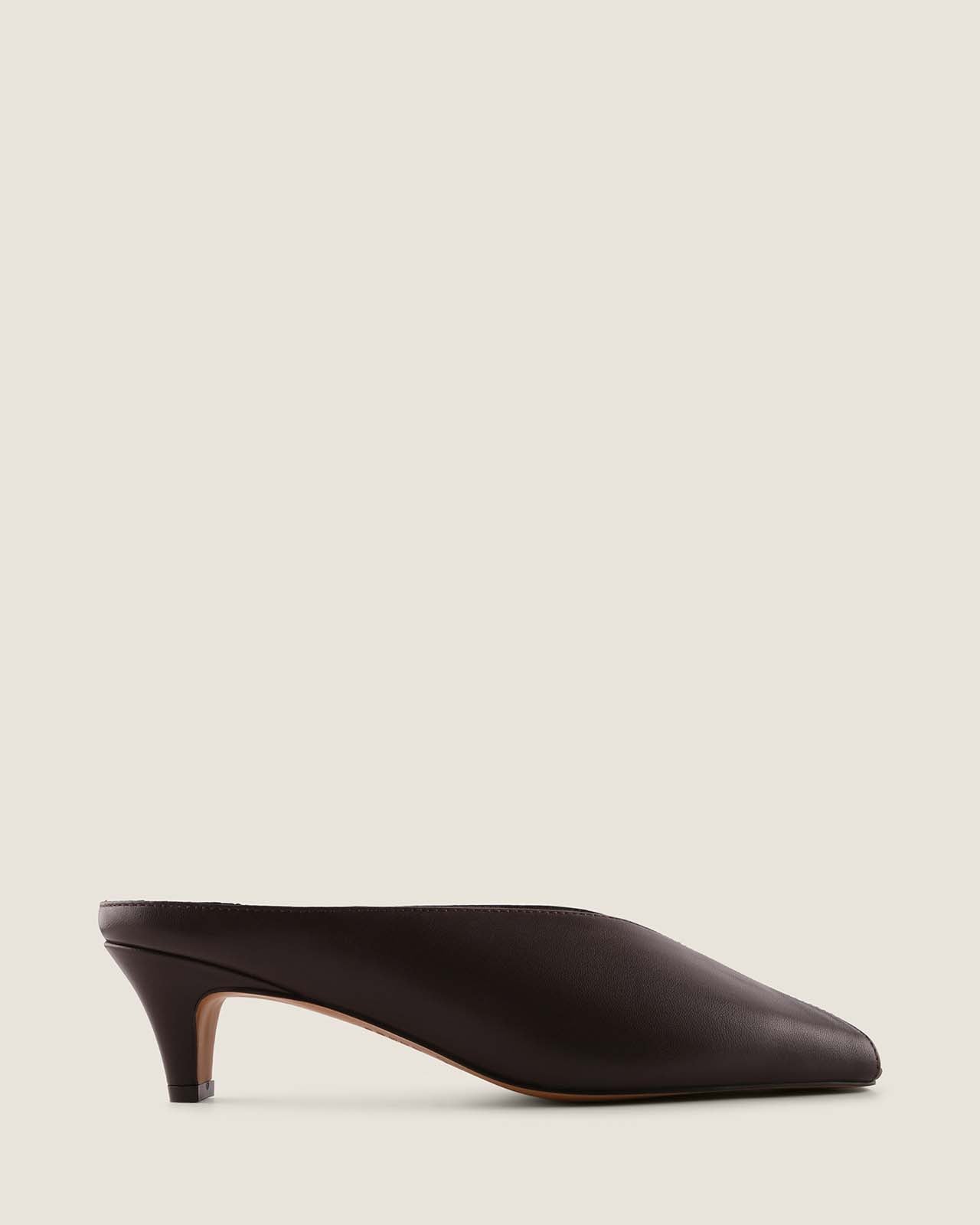 Brown high-heeled shoe on a light beige background