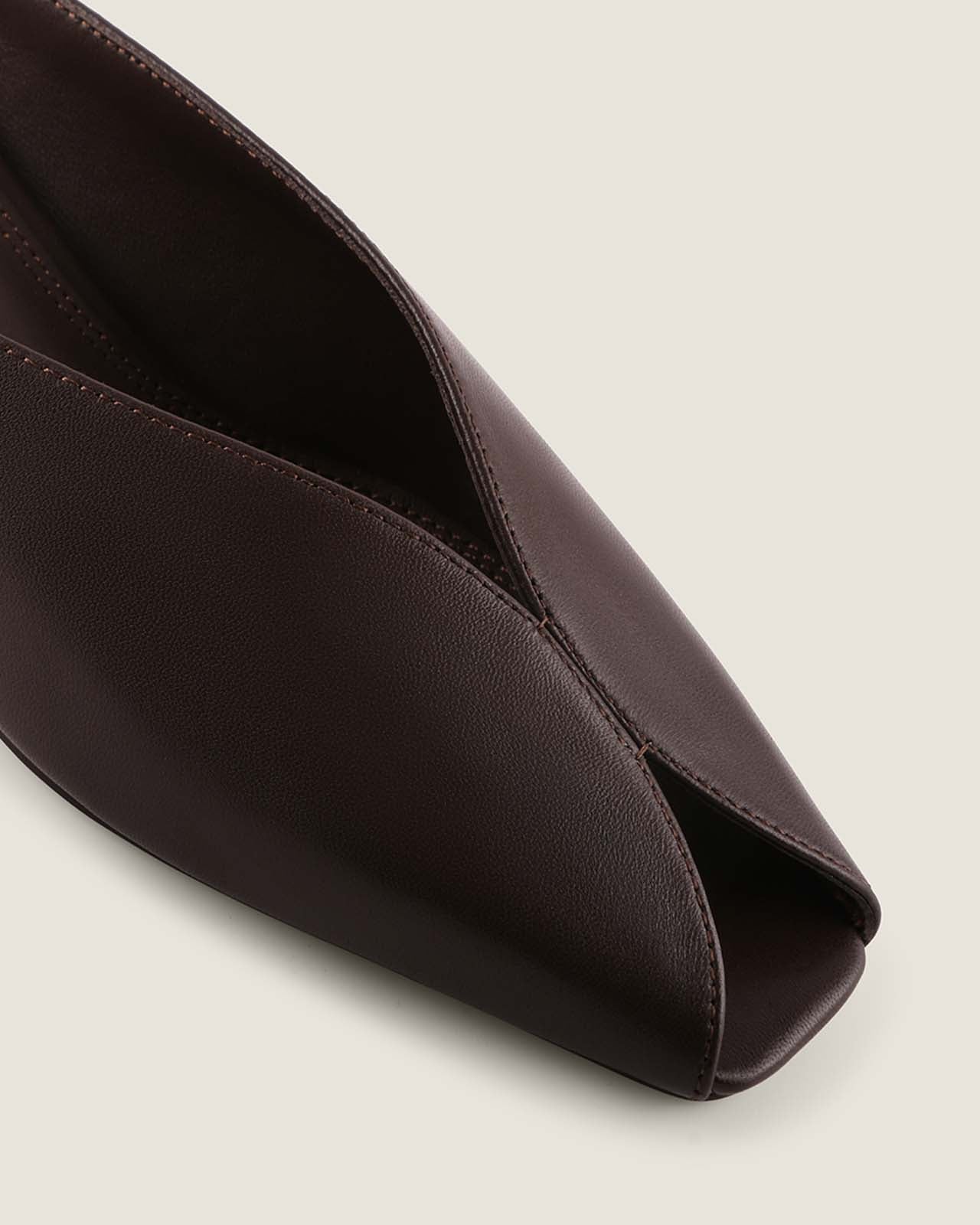 Brown leather heel on a light grey background