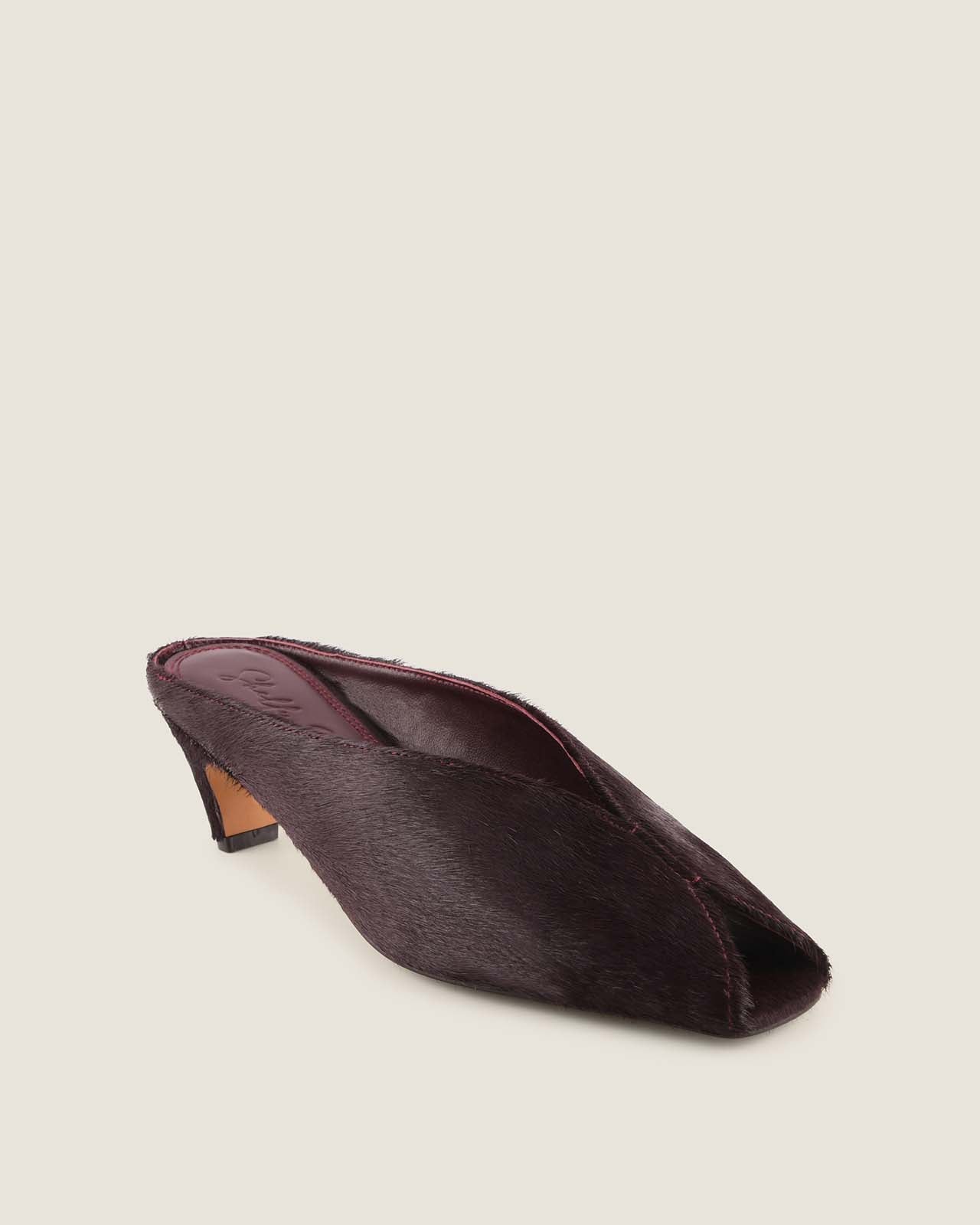 Burgundy low heel shoe on a light grey background