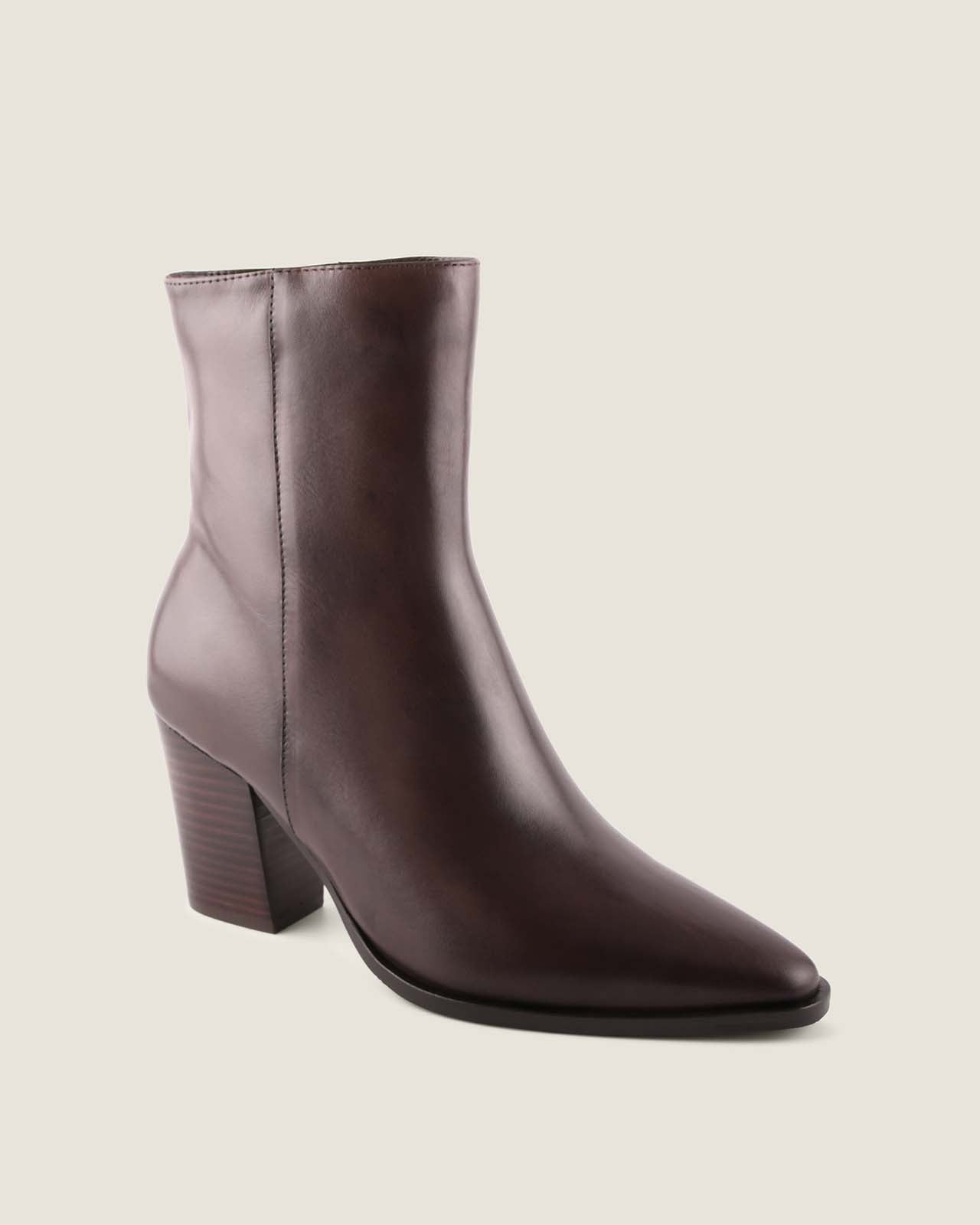 Brown leather ankle boot on a beige background