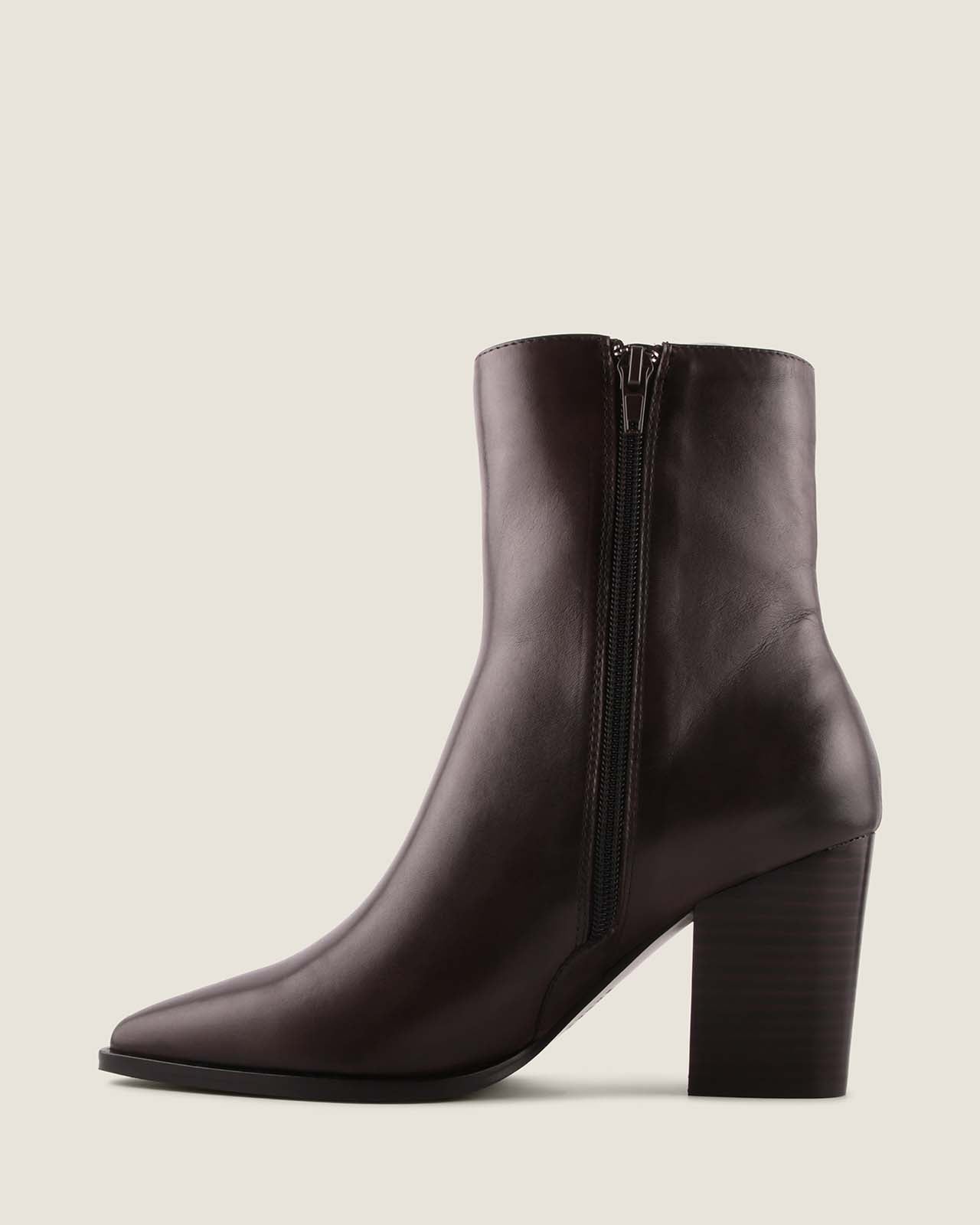 Dark brown leather ankle boot with a block heel on a light beige background