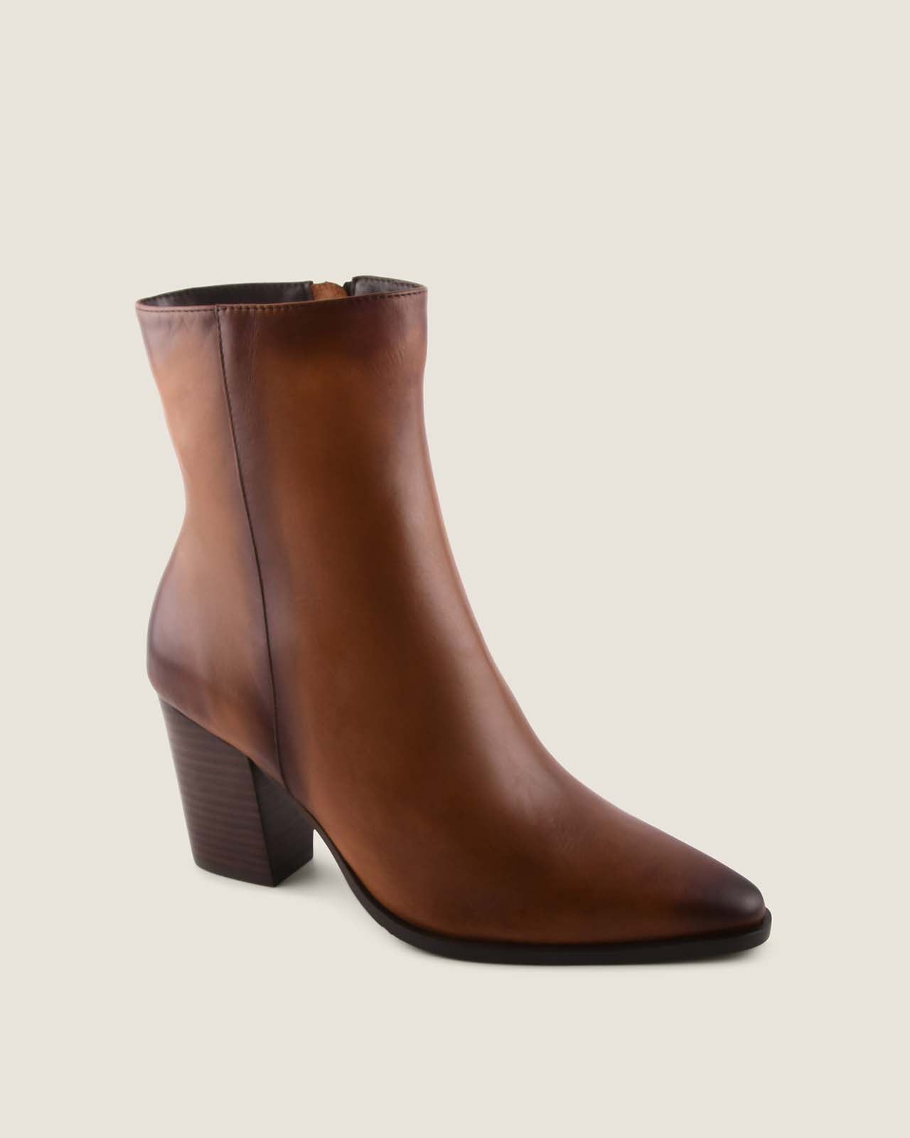 Brown ankle boot on a beige background