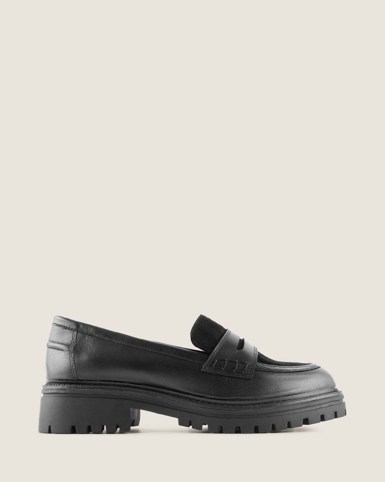 Black leather loafer on a light background