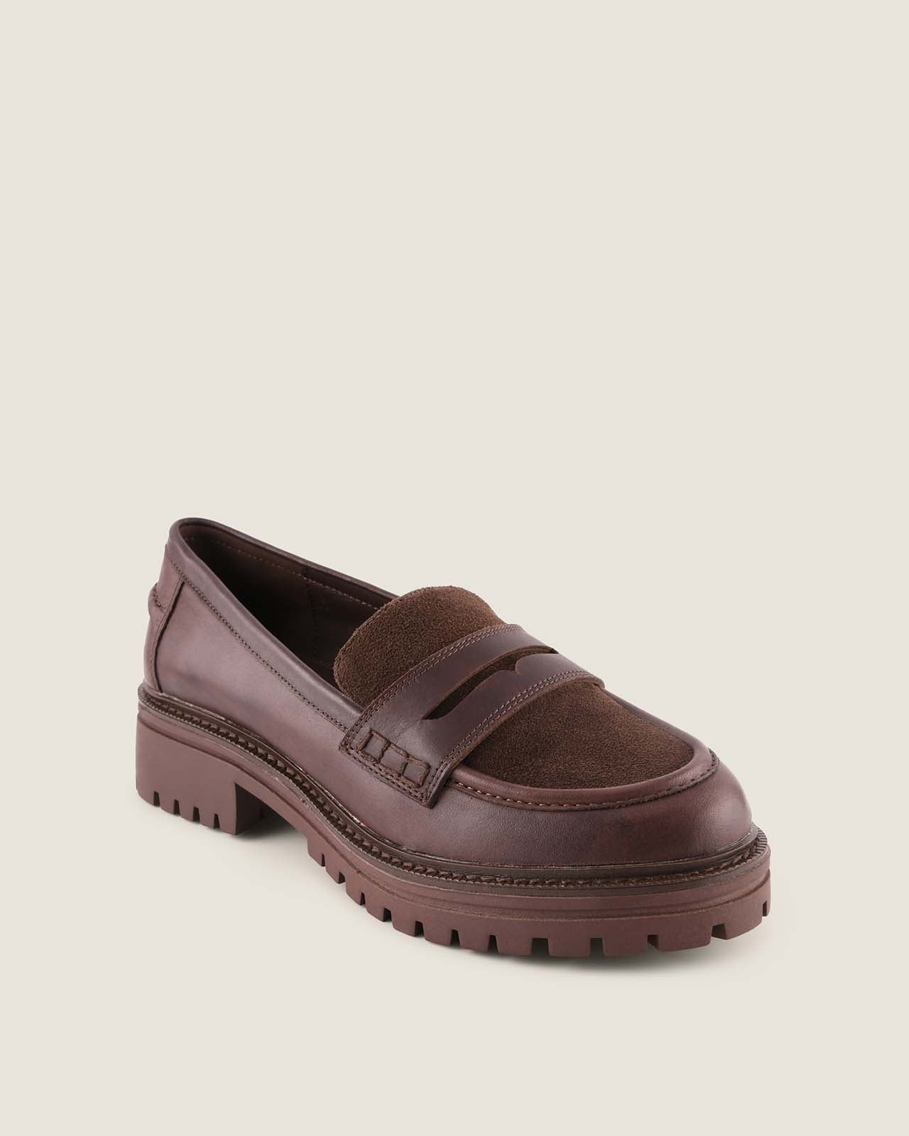 Brown loafer shoe on a beige background