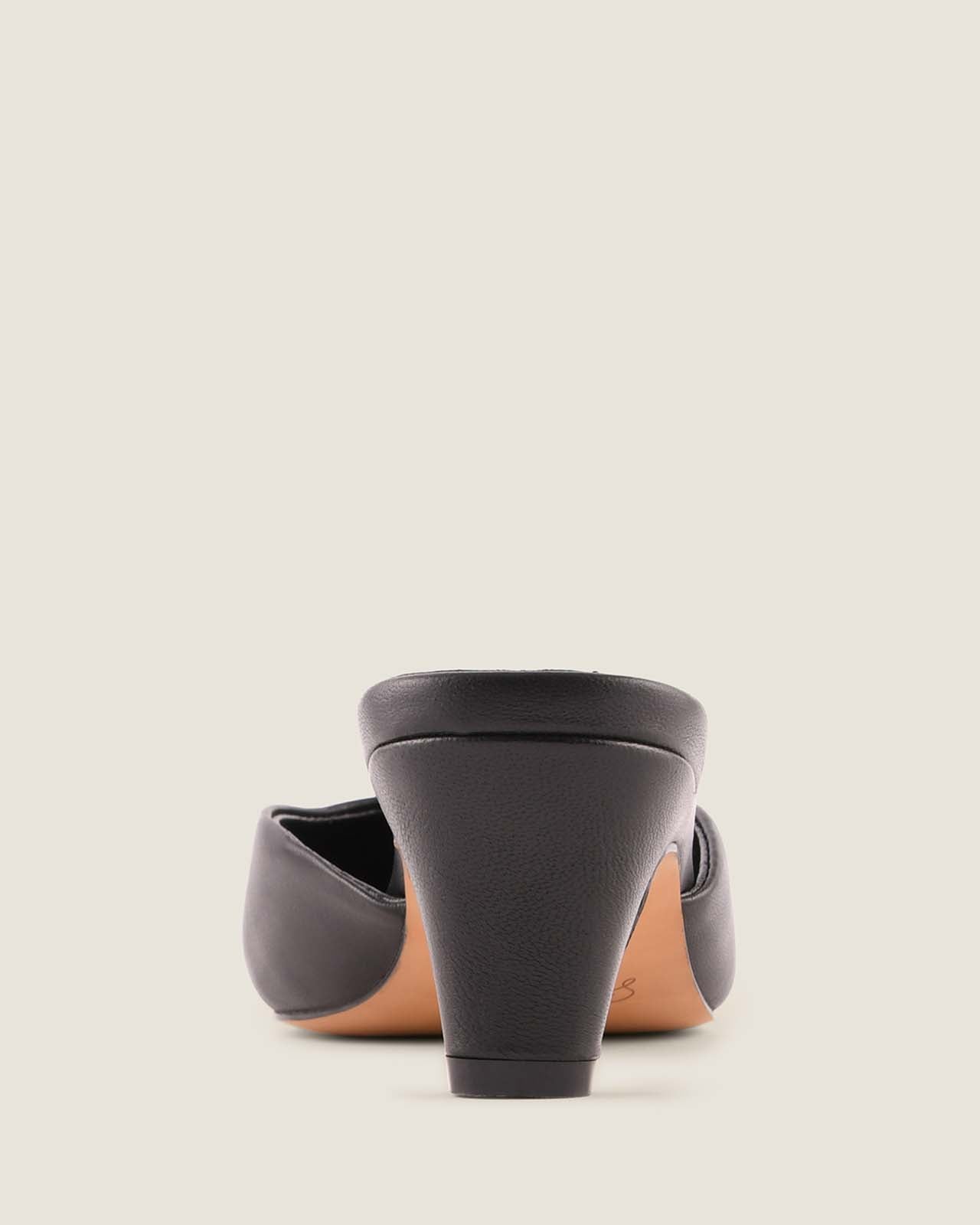 Black high-heeled shoe on a light grey background