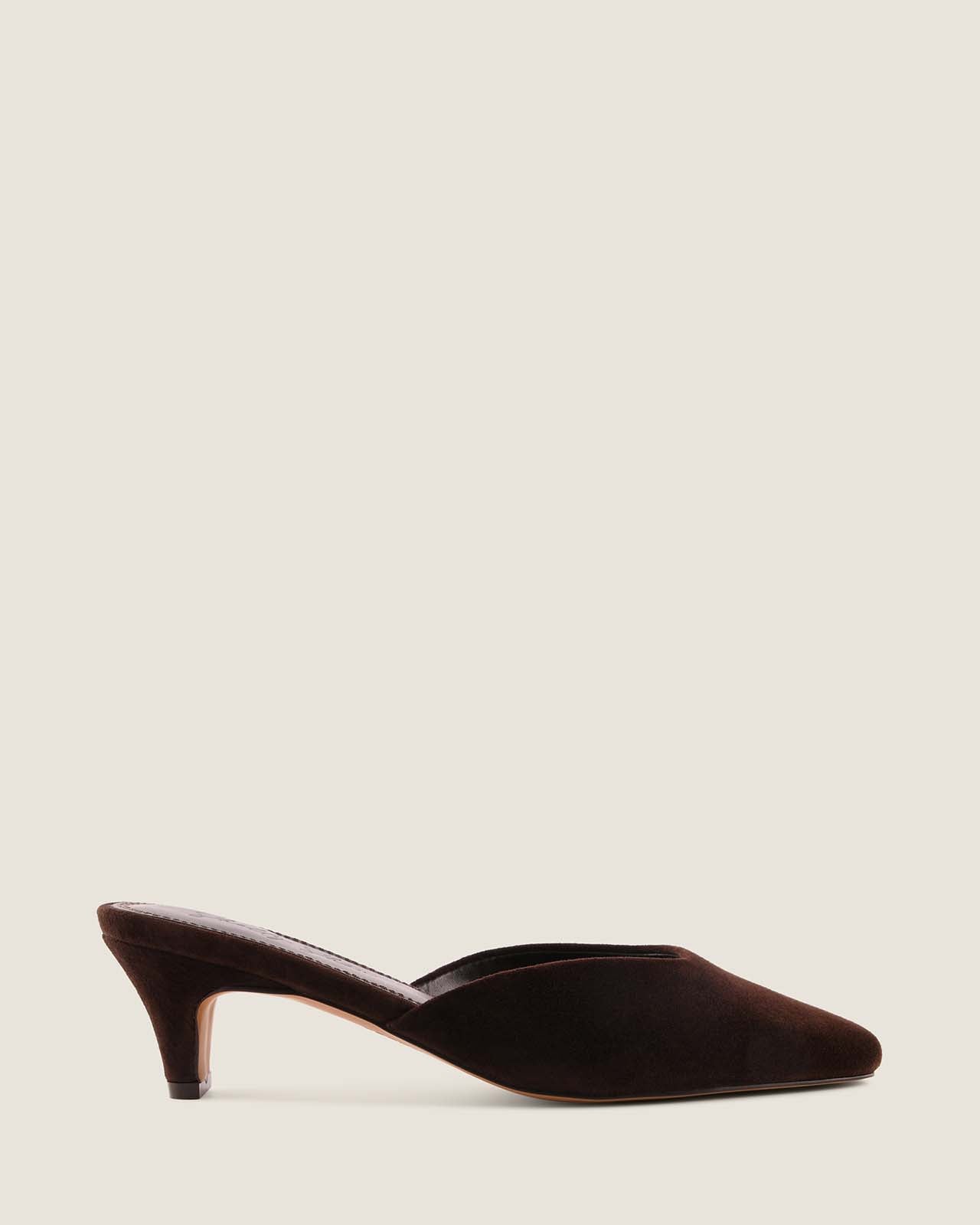 Brown suede high-heeled shoe on a light beige background