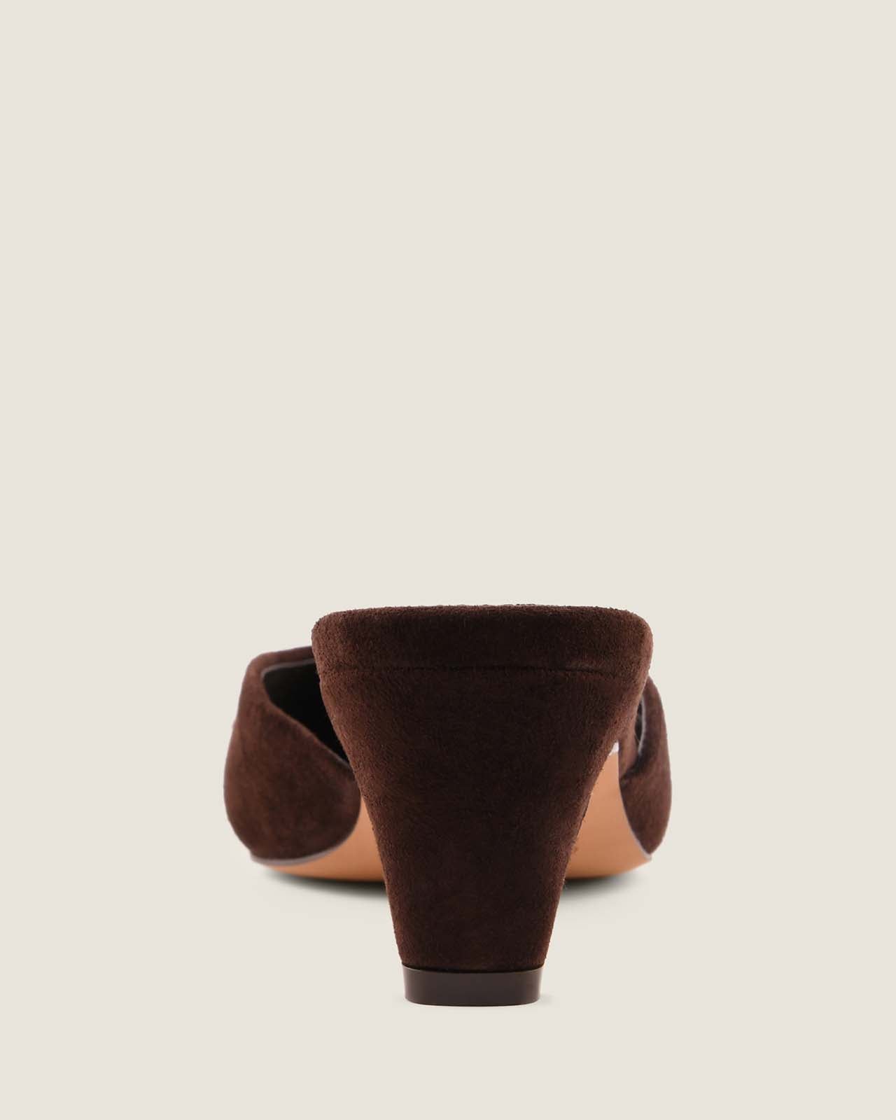 Brown suede shoe on a light beige background