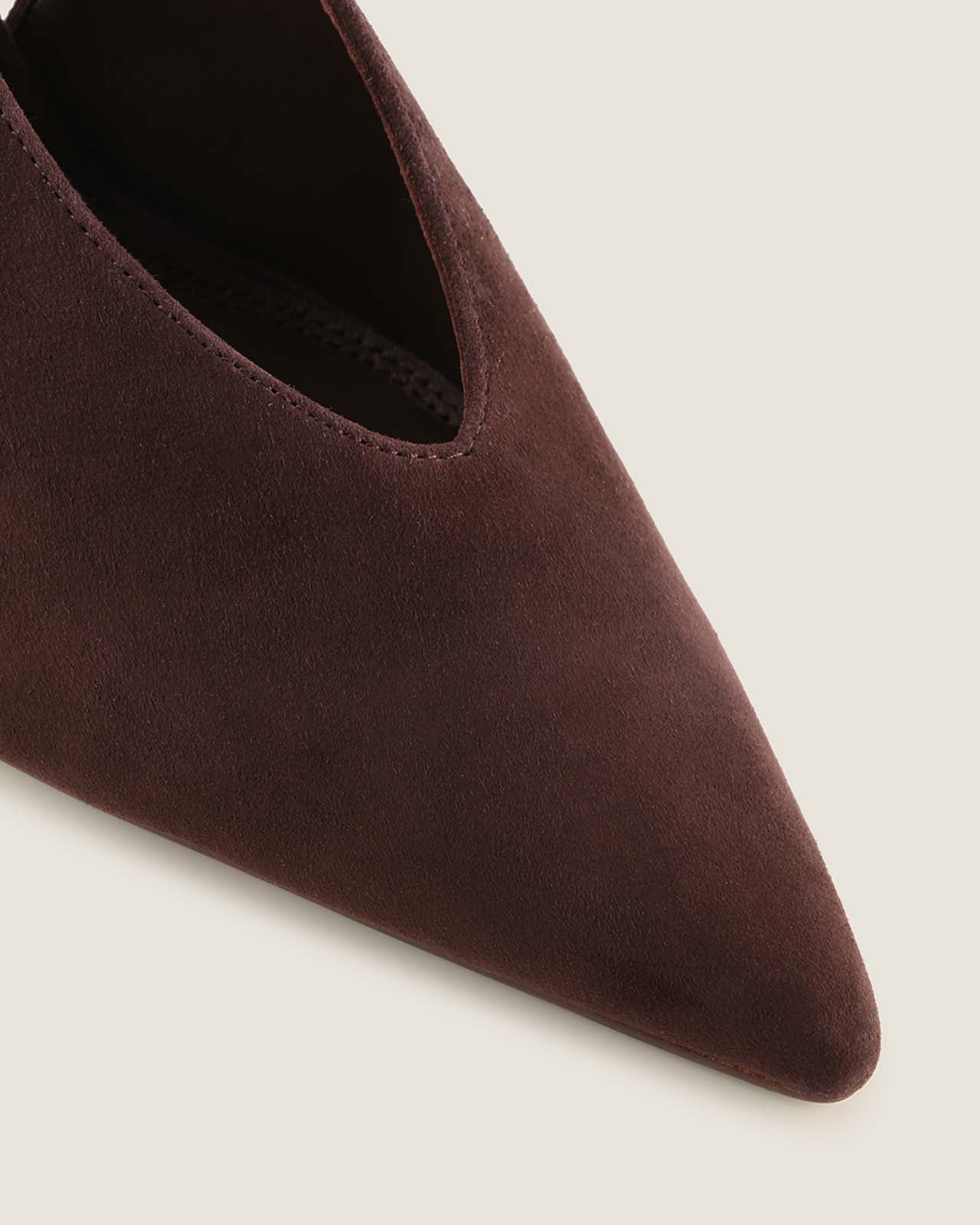 Brown pointed-toe shoe on a light grey background