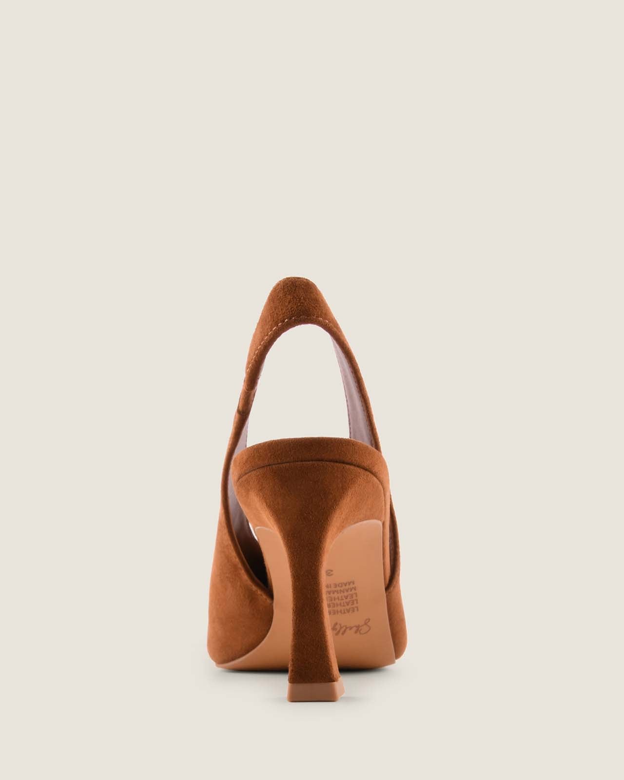 Tan suede high-heeled shoe on a light beige background