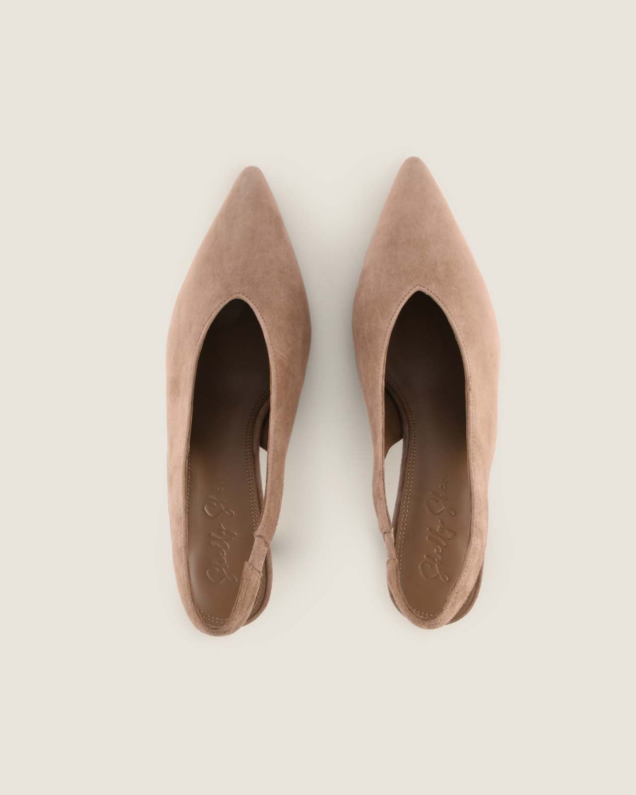 Pair of taupe pointed-toe shoes on a light background