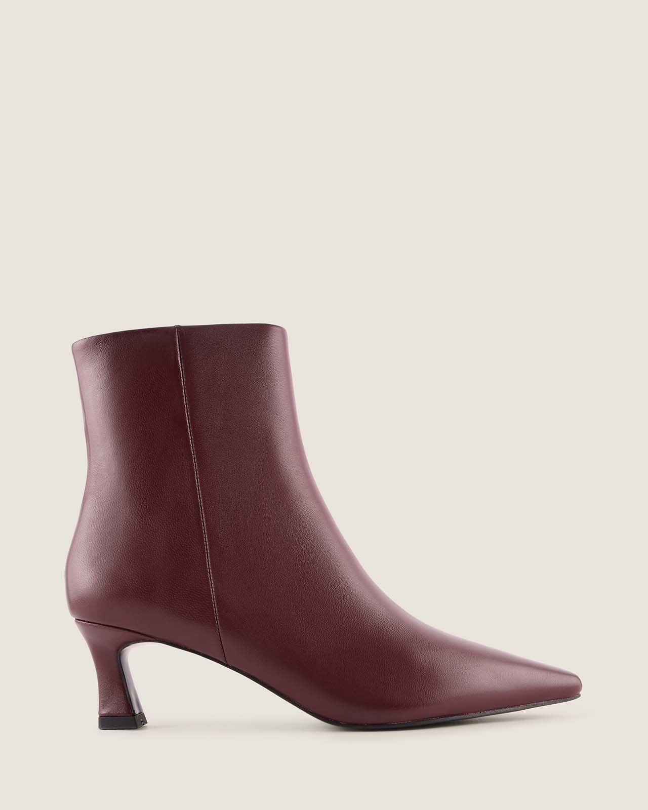 Burgundy ankle boot on a light beige background