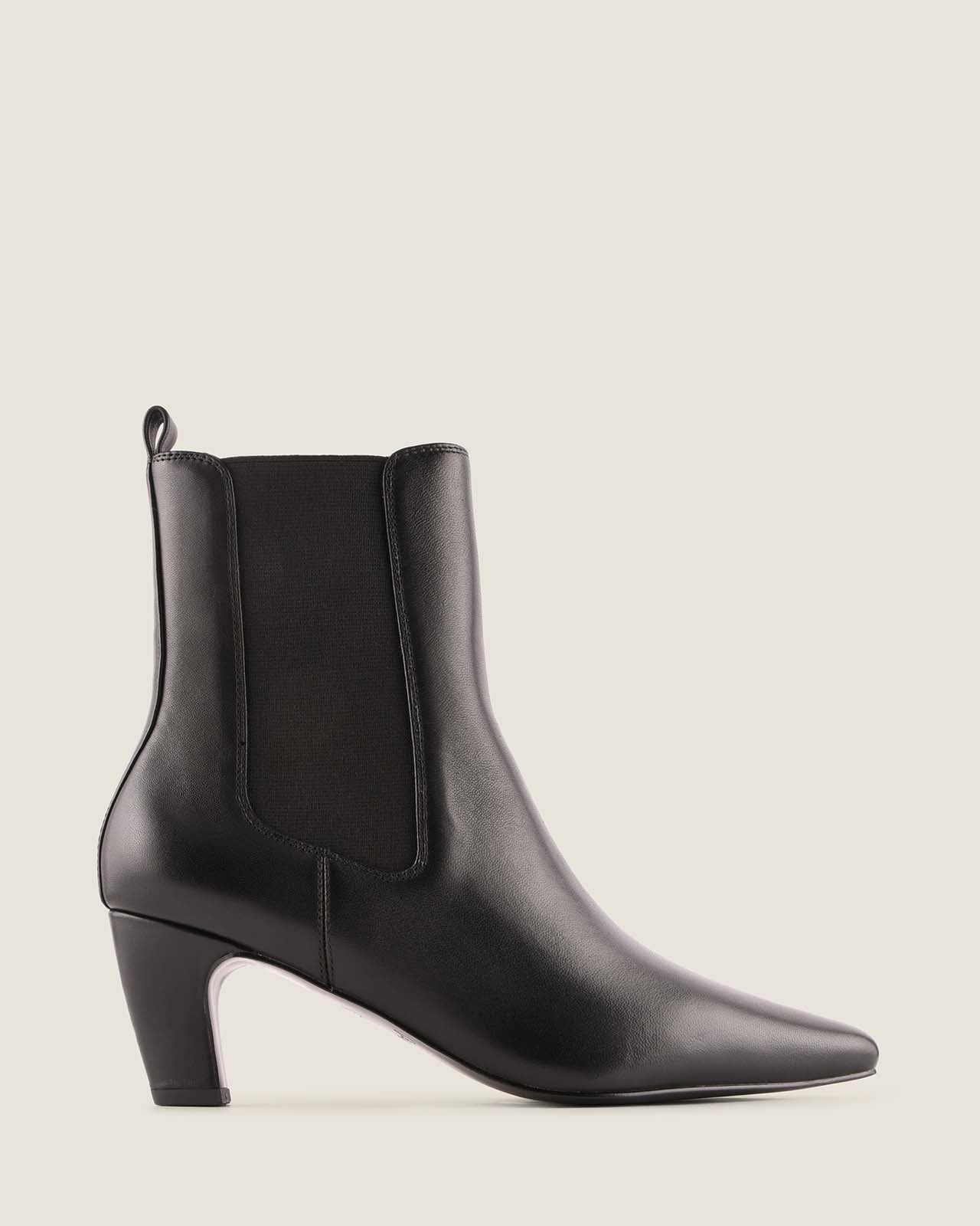 Black ankle boot on a light grey background