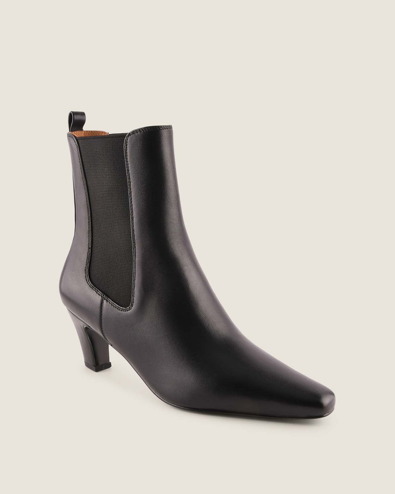 Black ankle boot on a light grey background