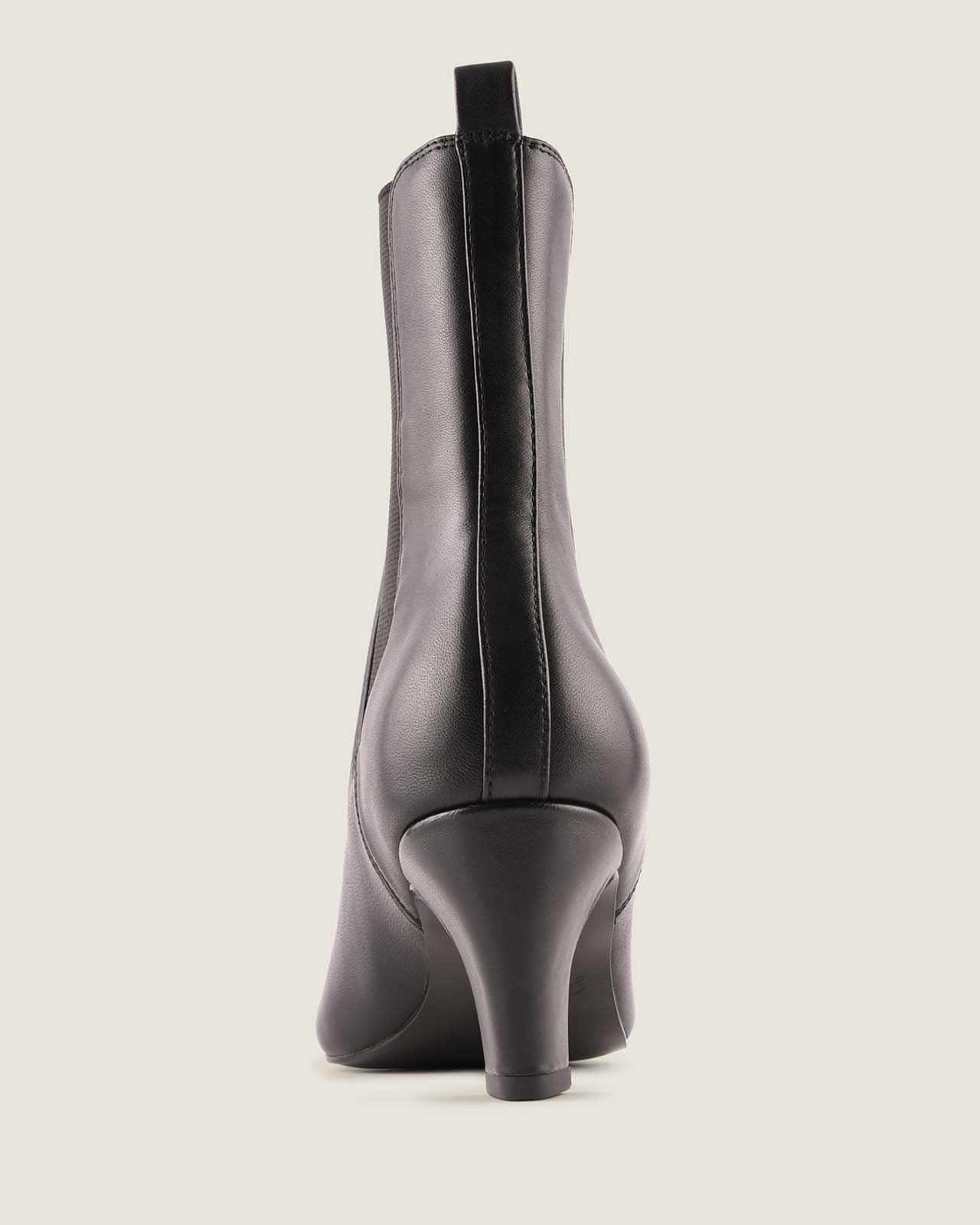 Black ankle boot on a light grey background