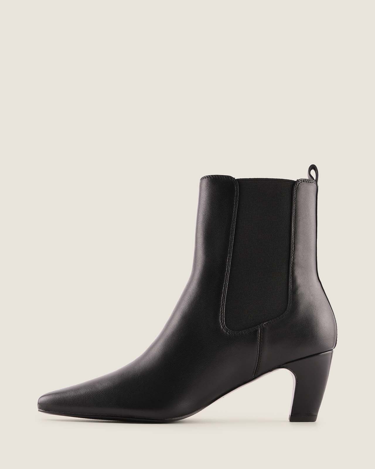 Black ankle boot on a light grey background