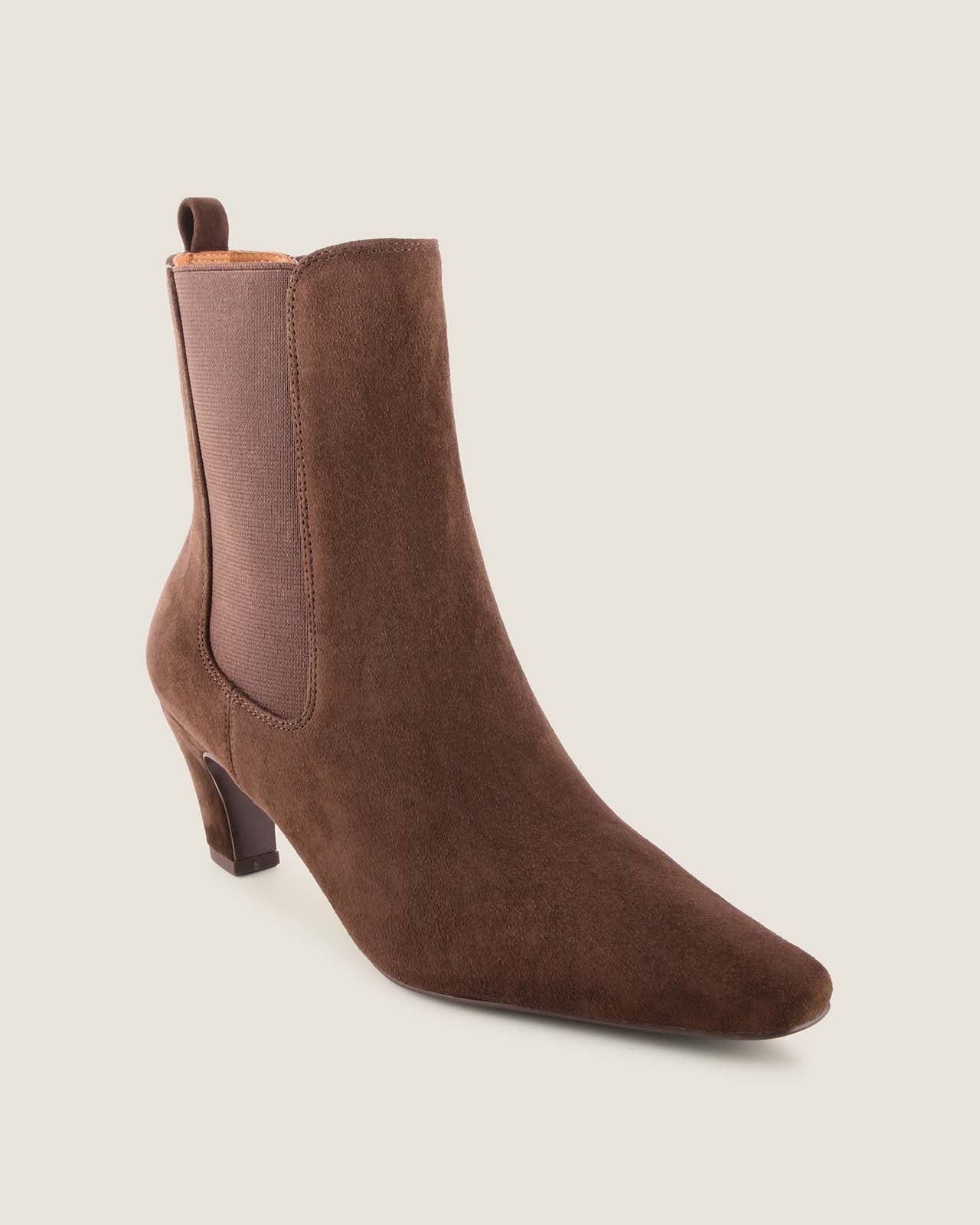 Chocolate suede ankle boot on a light beige background