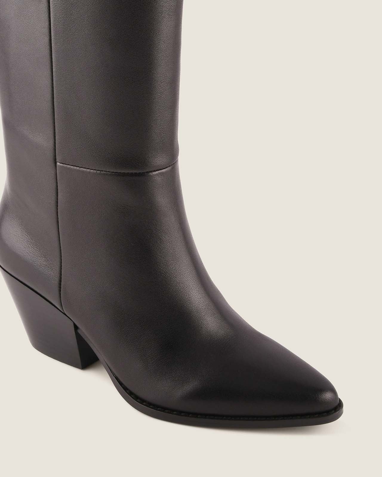 Black leather knee-high boot on a light grey background