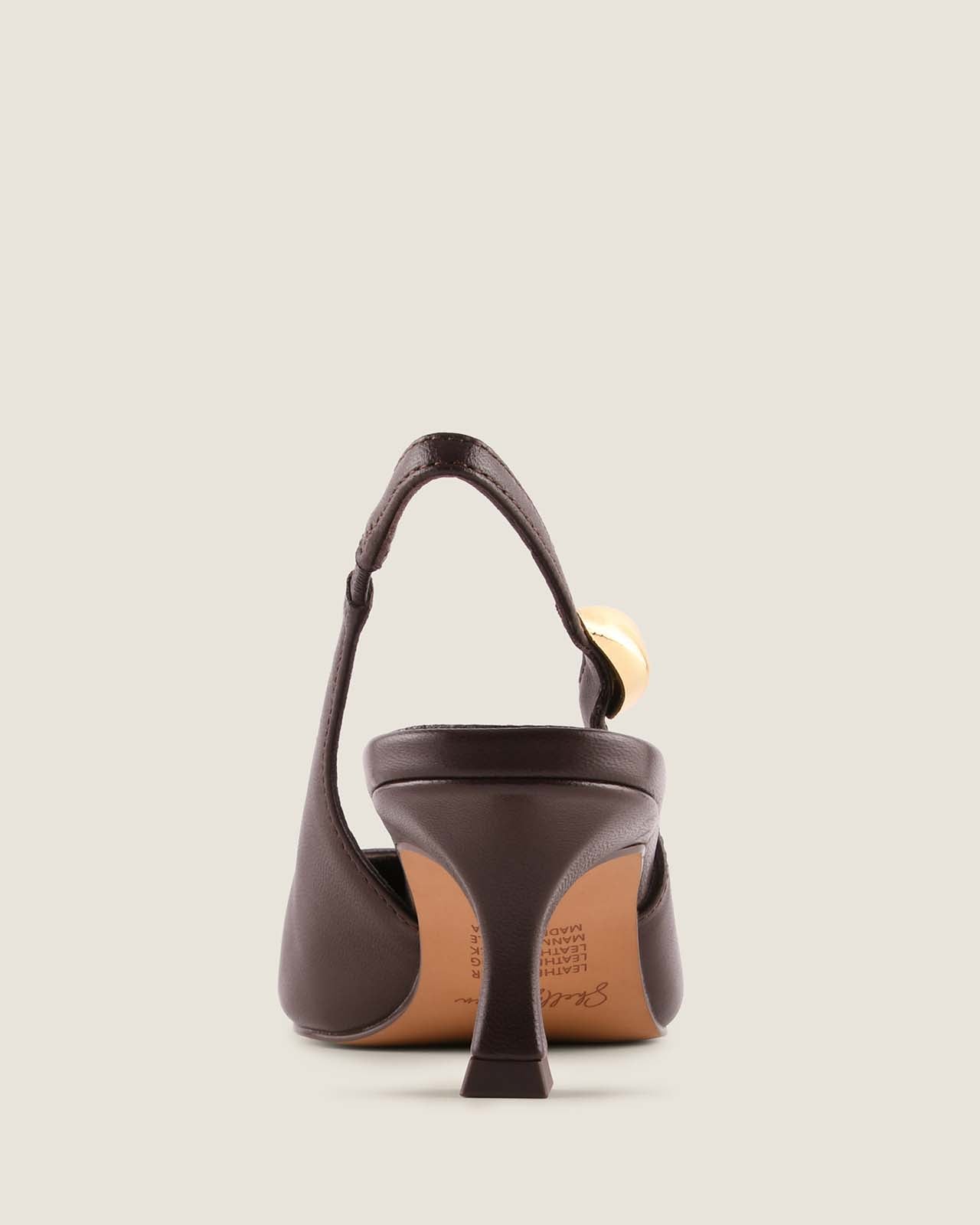 Brown leather slingback heel with a gold ornament detail on a light beige background