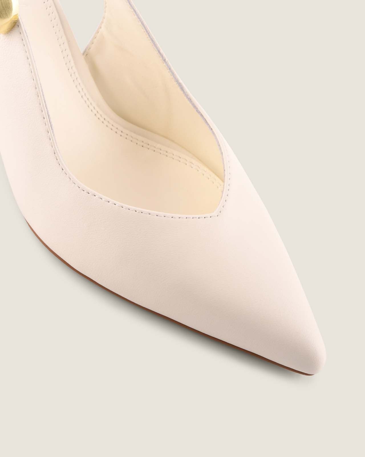Close-up of a white high-heeled shoe on a light grey background