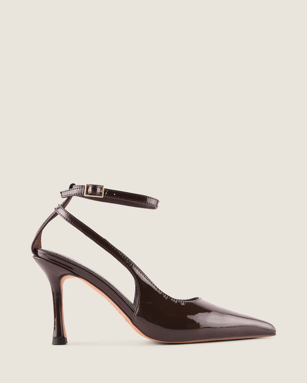 Brown patent leather high-heeled shoe on a beige background