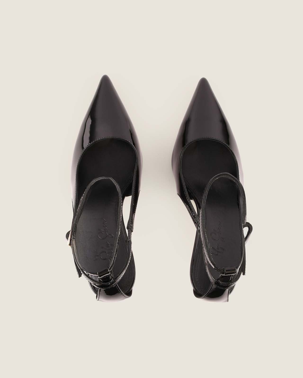 Pair of black high-heeled shoes on a light gray background
