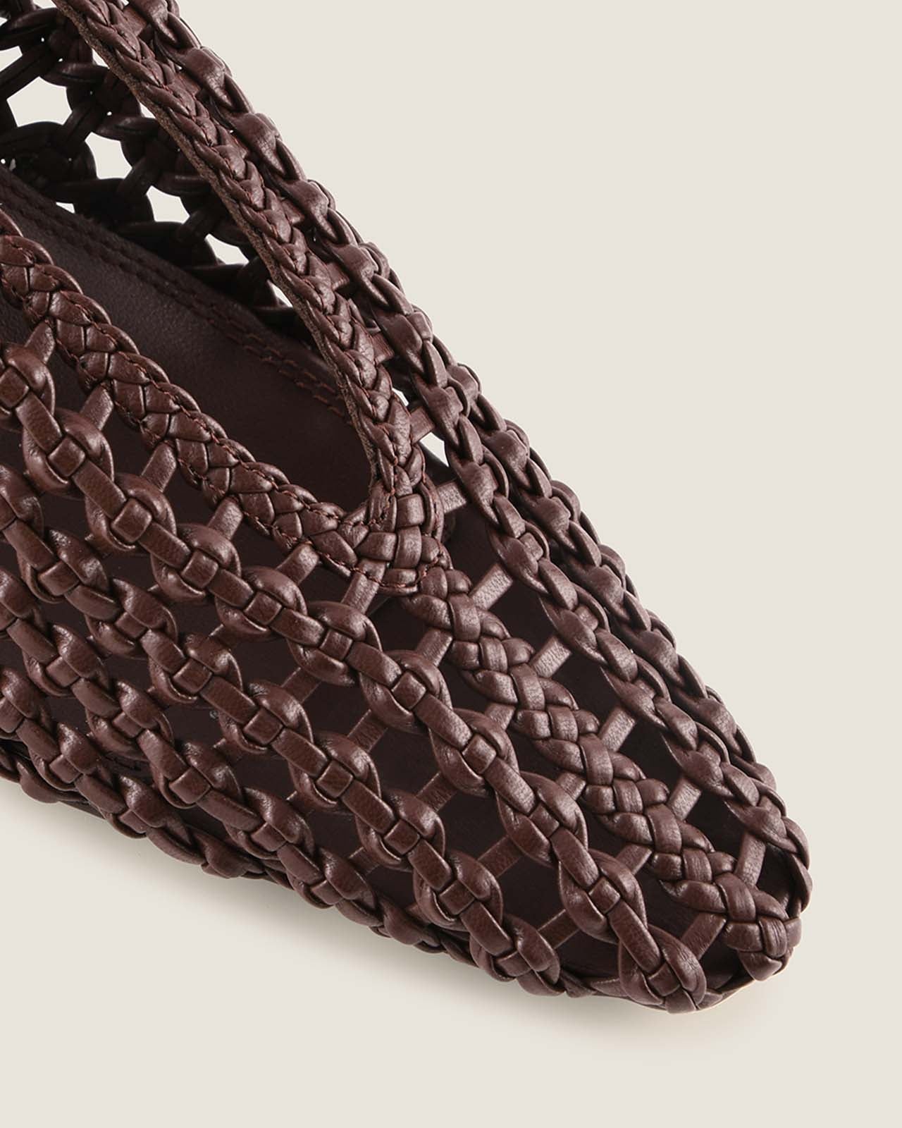 Brown woven shoe on a light beige background