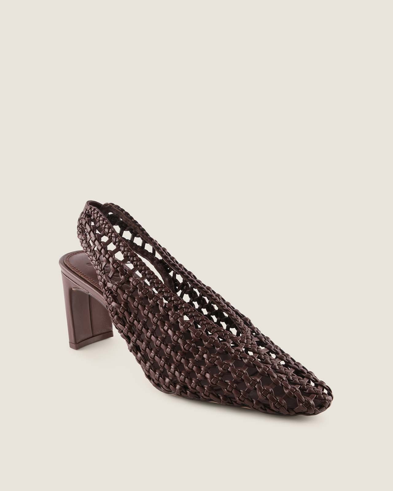 Brown leather woven shoe on a beige background