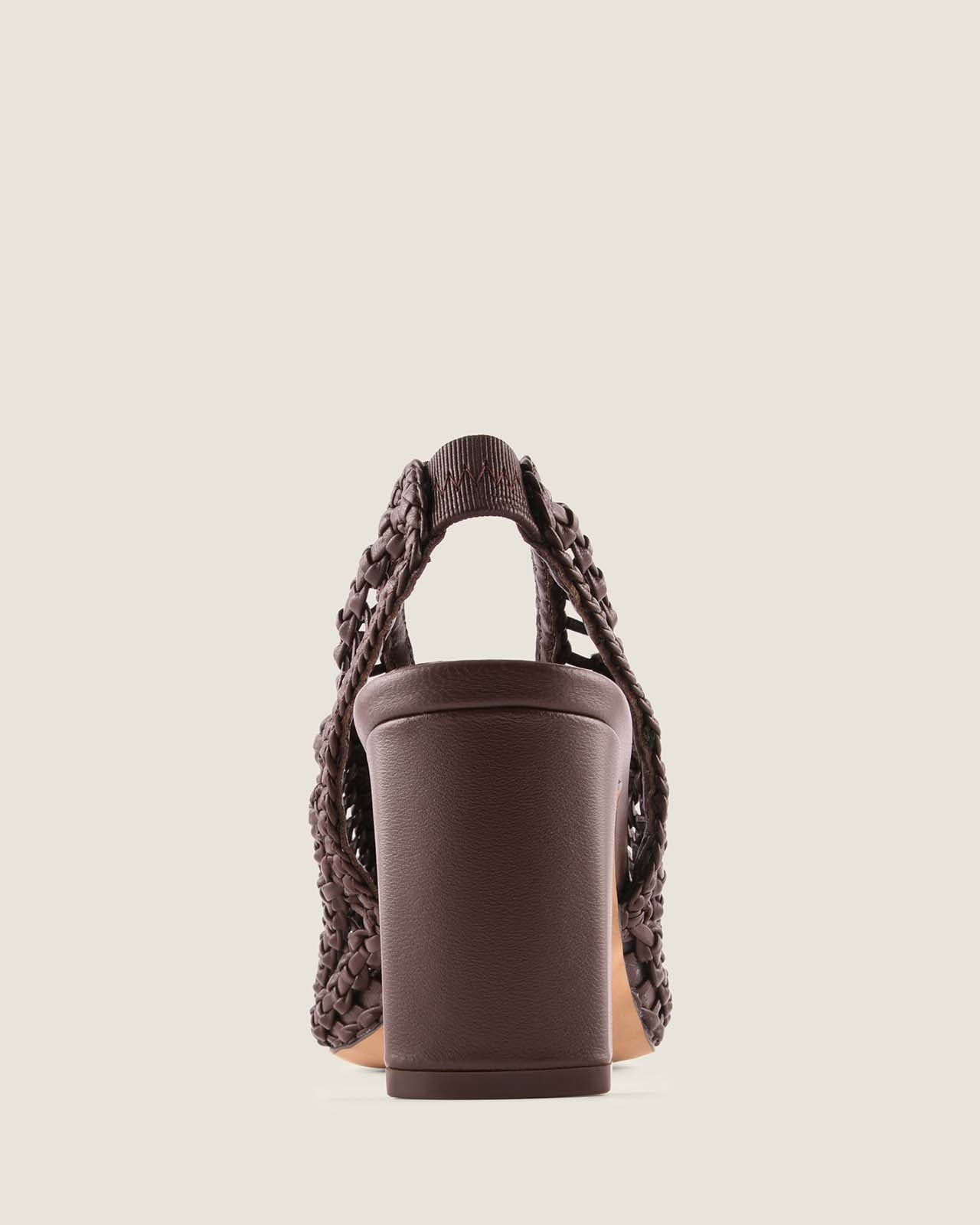 Brown heel with woven leather straps on a light beige background