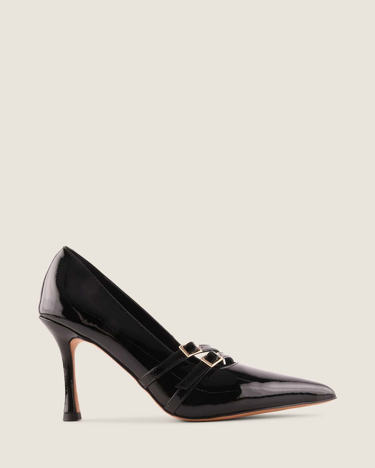 Black patent leather high-heeled shoe with a gold buckle on a light grey background