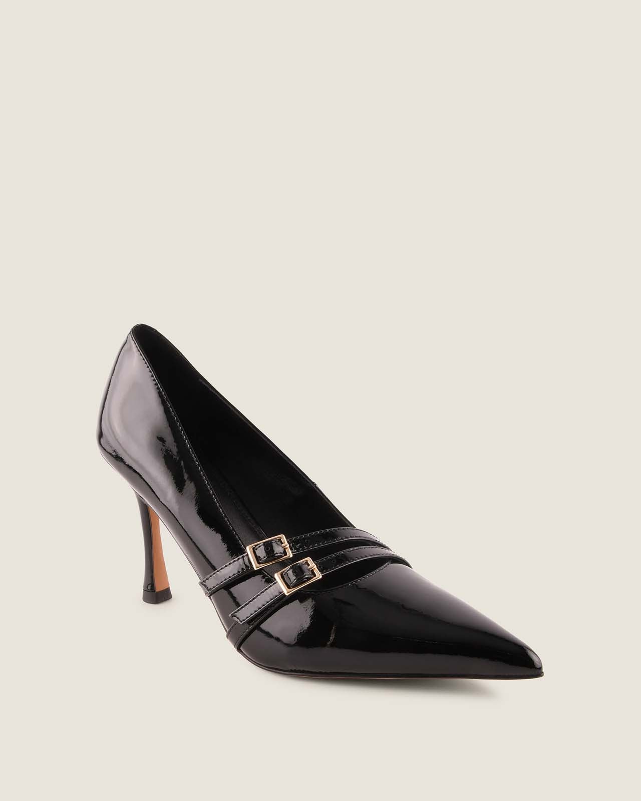 Black high-heeled shoe with a strap on a light grey background