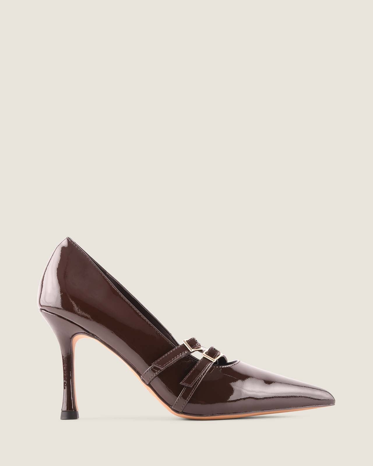 Brown patent leather high-heeled shoe on a light beige background
