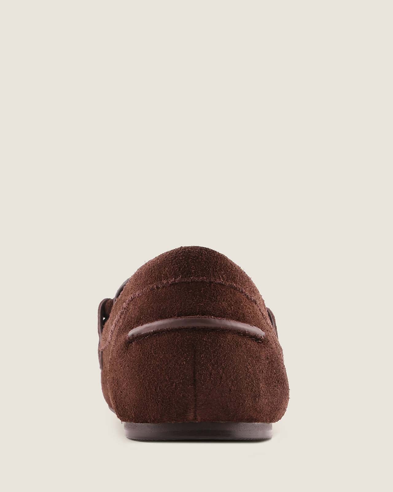 Brown suede loafer on a light beige background