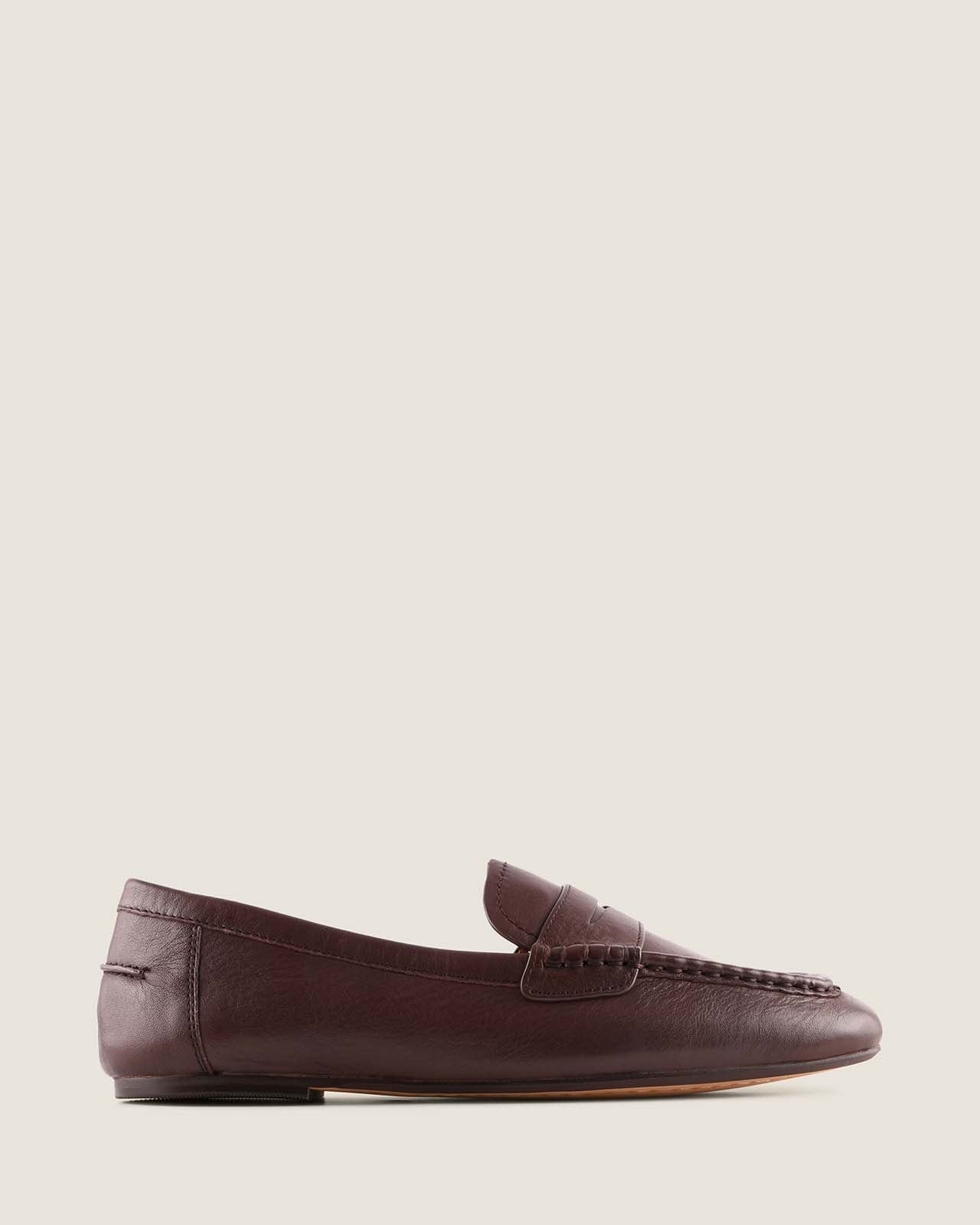 Brown leather loafer shoe on a light background