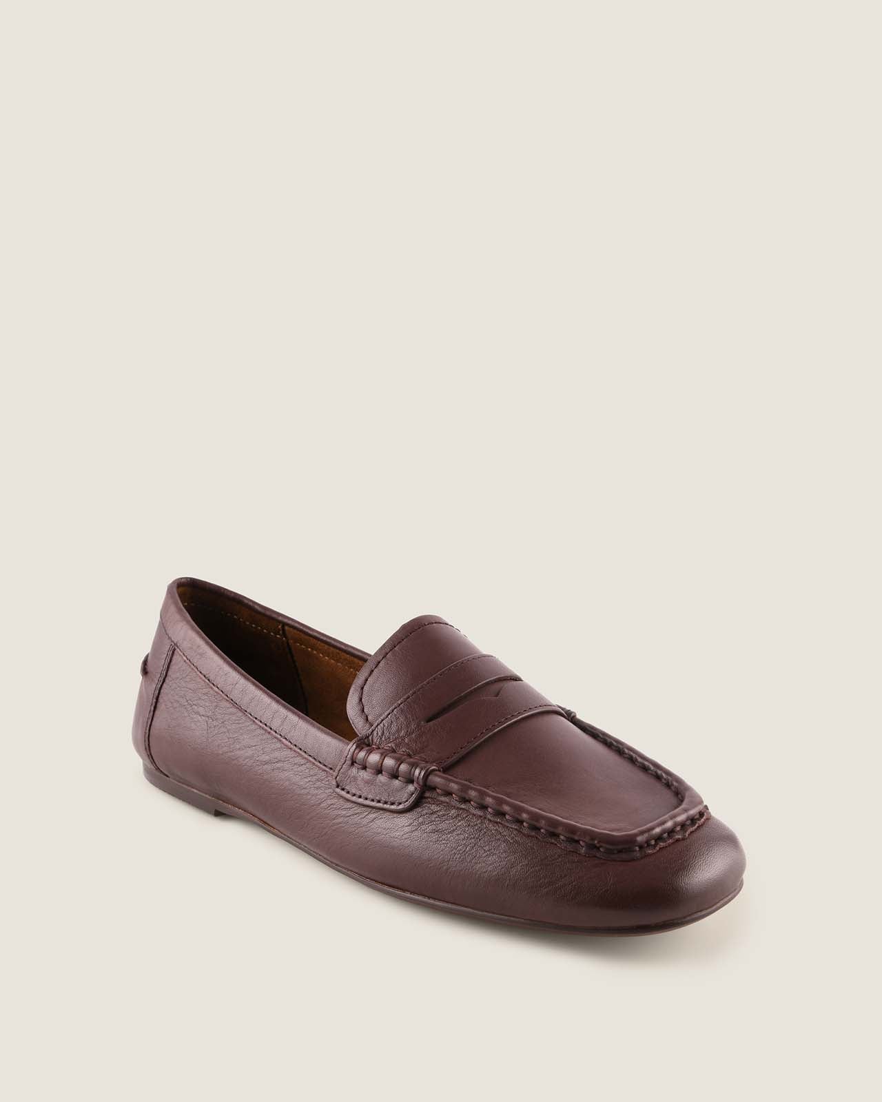 Brown leather loafer shoe on a light background