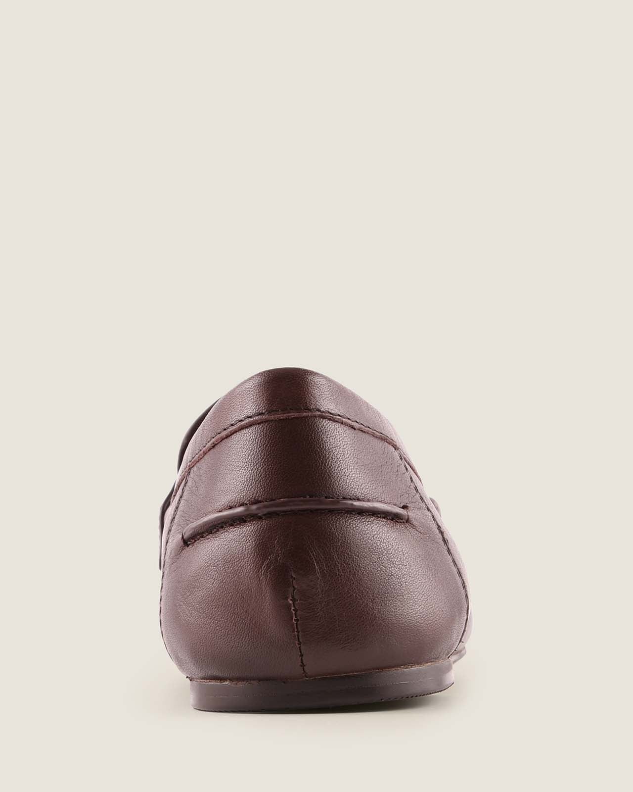Brown leather loafer shoe on a light background