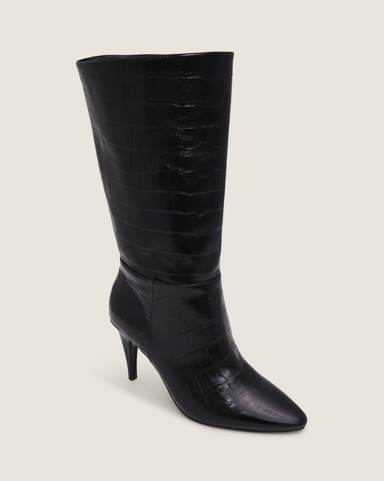 Black knee-high boot with a high heel on a beige background